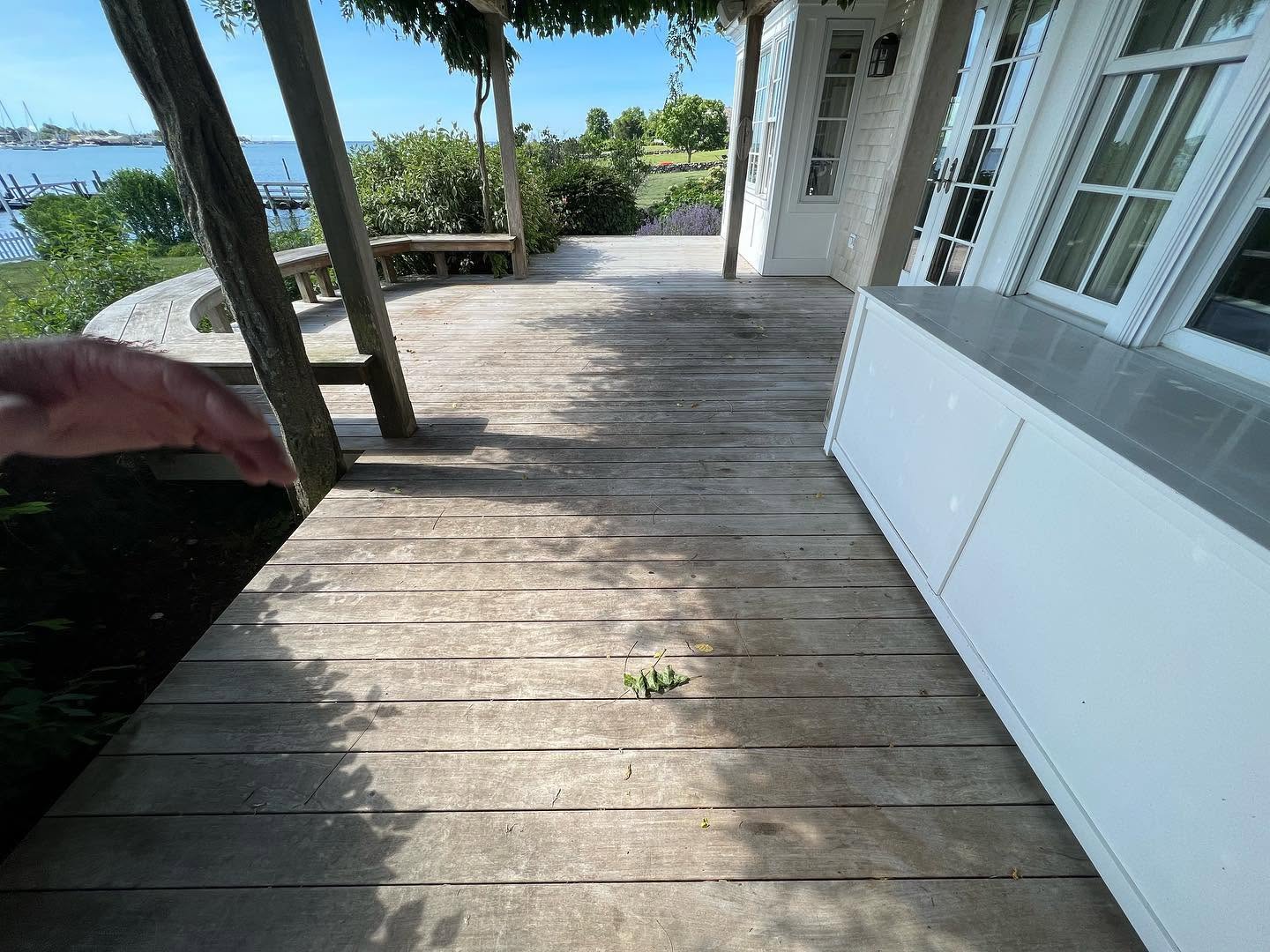 Weathered waterfront deck before professional restoration
